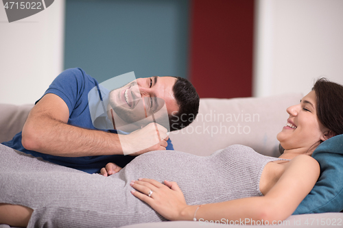 Image of future dad listening the belly of his pregnant wife