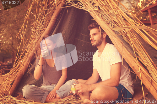 Image of couple spending time together in straw tent