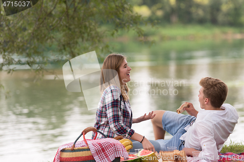 Image of Couple in love enjoying picnic time