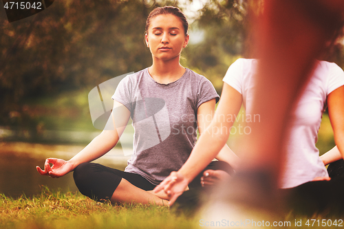 Image of women meditating and doing yoga exercise