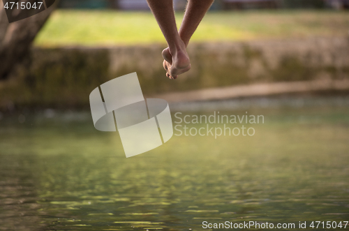 Image of people sitting at wooden bridge