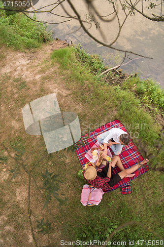 Image of top view of couple enjoying picnic time