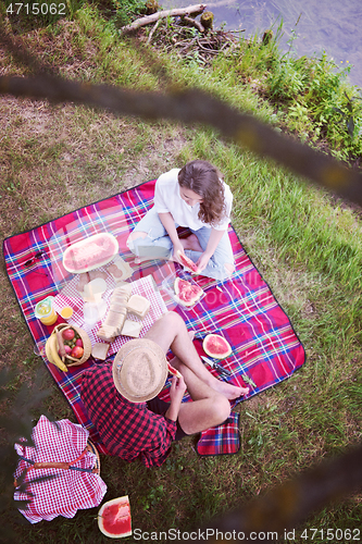 Image of top view of couple enjoying picnic time