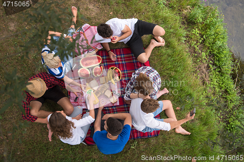 Image of top view of group friends enjoying picnic time