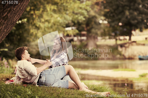 Image of Couple in love enjoying picnic time