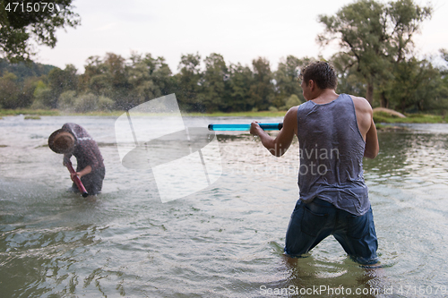 Image of young men having fun with water guns