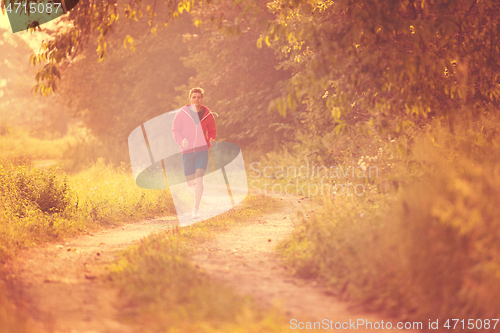 Image of man jogging along a country road