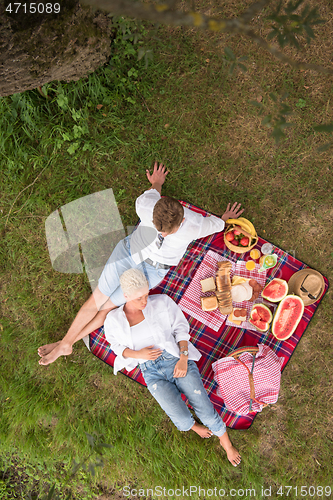 Image of top view of couple enjoying picnic time