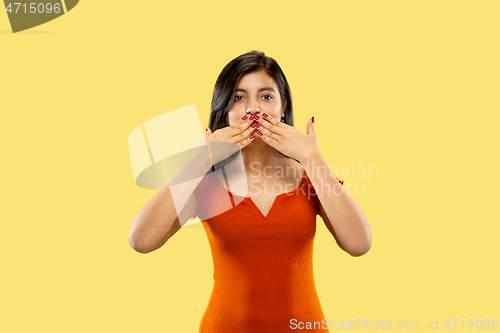 Image of Portrait of beautiful woman isolated on yellow studio background