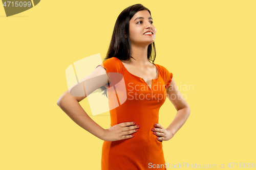 Image of Portrait of beautiful woman isolated on yellow studio background