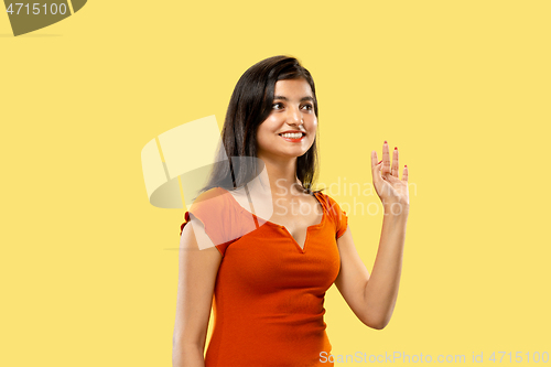 Image of Portrait of beautiful woman isolated on yellow studio background