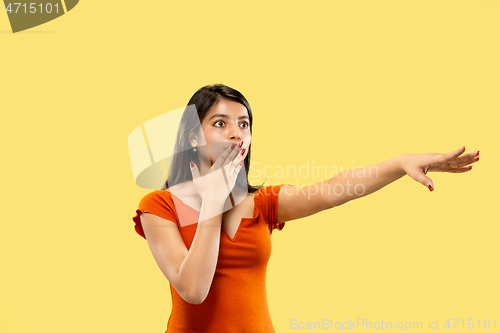 Image of Portrait of beautiful woman isolated on yellow studio background