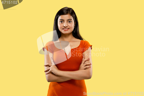 Image of Portrait of beautiful woman isolated on yellow studio background