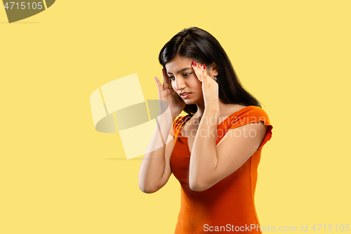 Image of Portrait of beautiful woman isolated on yellow studio background