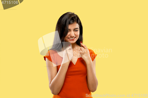 Image of Portrait of beautiful woman isolated on yellow studio background