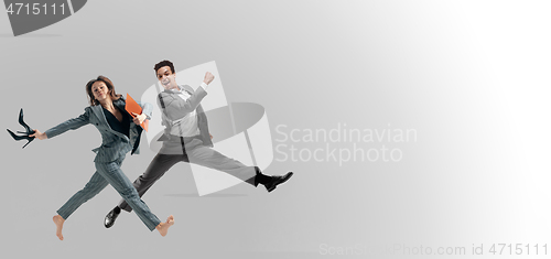 Image of Office workers jumping isolated on studio background