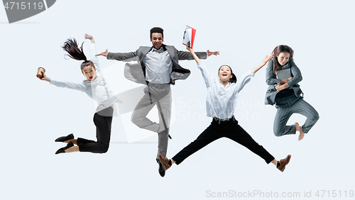 Image of Office workers jumping isolated on studio background