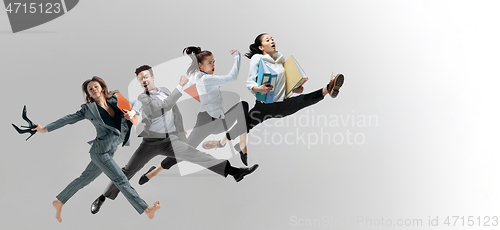 Image of Office workers jumping isolated on studio background