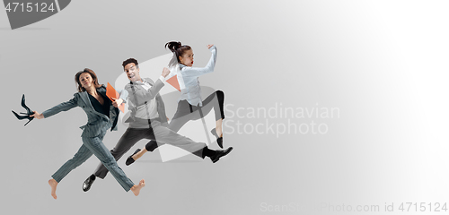 Image of Office workers jumping isolated on studio background