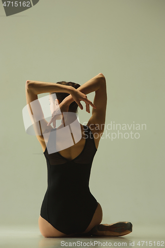 Image of Young graceful female ballet dancer dancing in mixed light