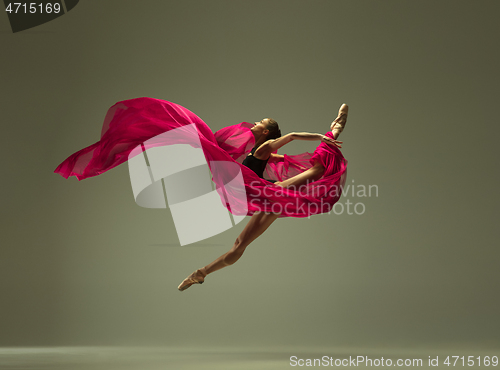 Image of Young graceful female ballet dancer dancing in mixed light