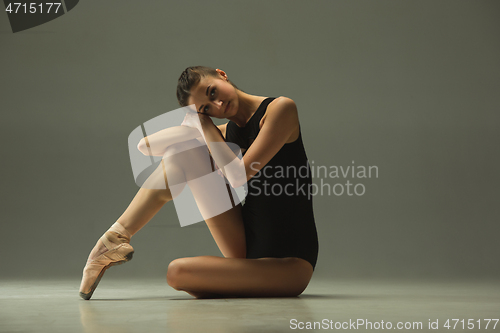 Image of Young graceful female ballet dancer dancing in mixed light