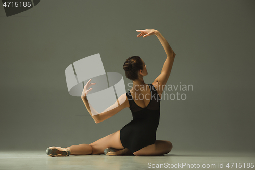 Image of Young graceful female ballet dancer dancing in mixed light