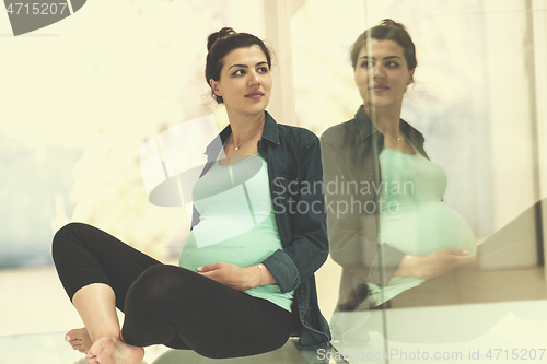 Image of pregnant women sitting on the floor