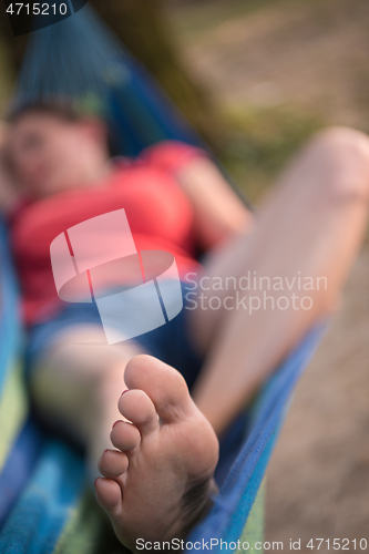 Image of woman resting on hammock