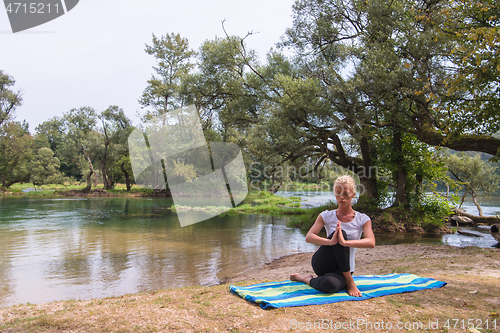 Image of woman meditating and doing yoga exercise