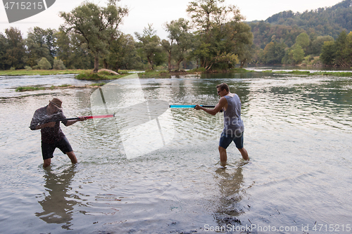 Image of young men having fun with water guns