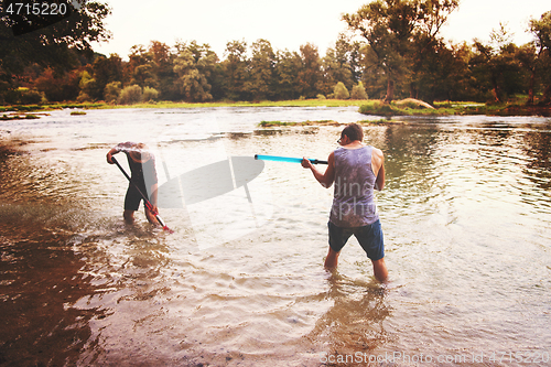 Image of young men having fun with water guns