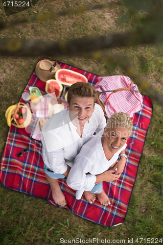 Image of top view of couple enjoying picnic time