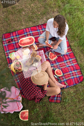 Image of top view of couple enjoying picnic time