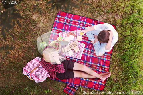 Image of top view of couple enjoying picnic time