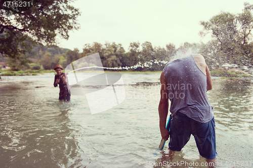 Image of young men having fun with water guns