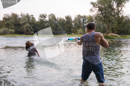 Image of young men having fun with water guns