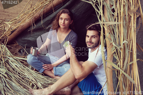 Image of couple spending time together in straw tent