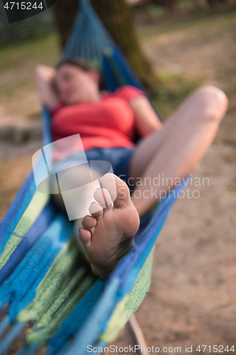 Image of woman resting on hammock