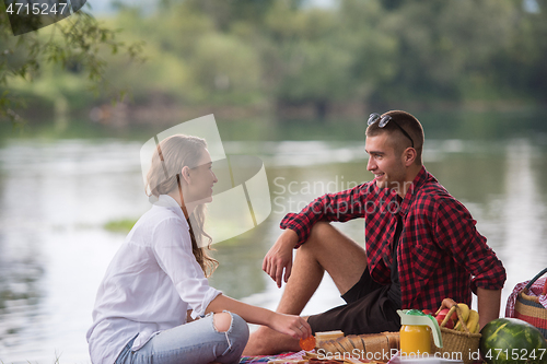 Image of Couple in love enjoying picnic time