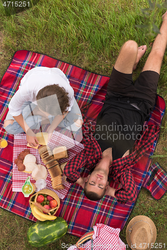 Image of top view of couple enjoying picnic time