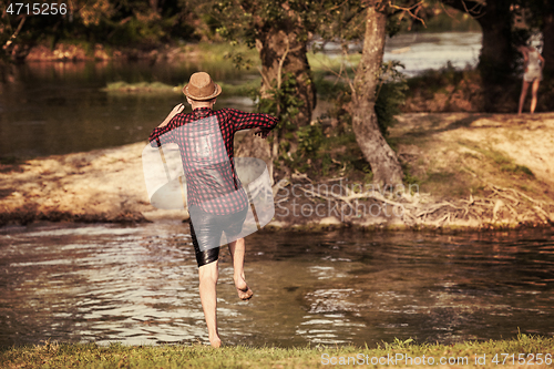 Image of man jumping into the river