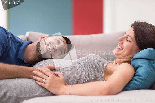 Image of future dad listening the belly of his pregnant wife