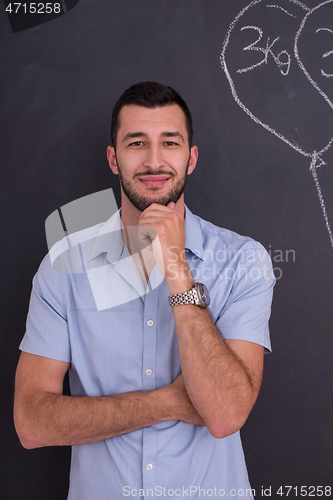 Image of portrait of man in front of black chalkboard