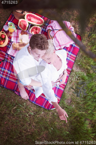 Image of top view of couple enjoying picnic time