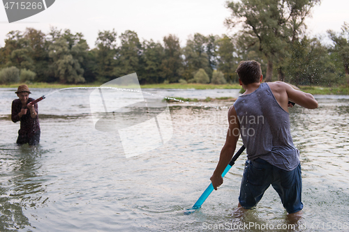 Image of young men having fun with water guns