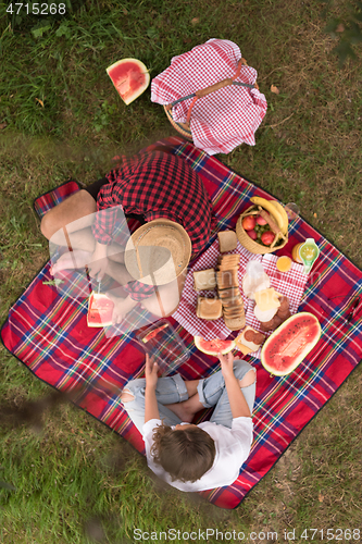 Image of top view of couple enjoying picnic time