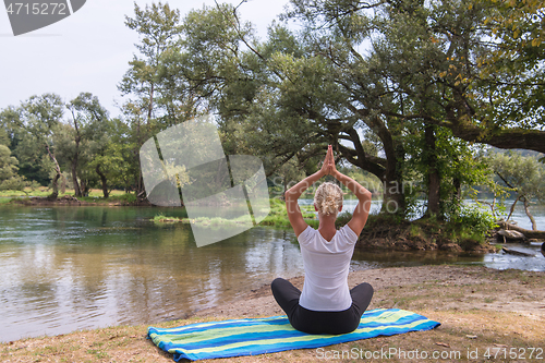 Image of woman meditating and doing yoga exercise