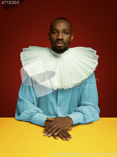 Image of Young man as a medieval grandee on red background