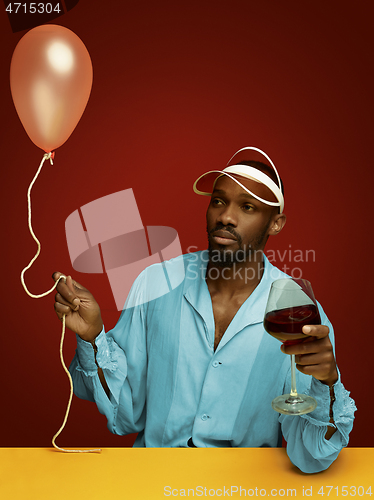 Image of Young man as a medieval knight on red background